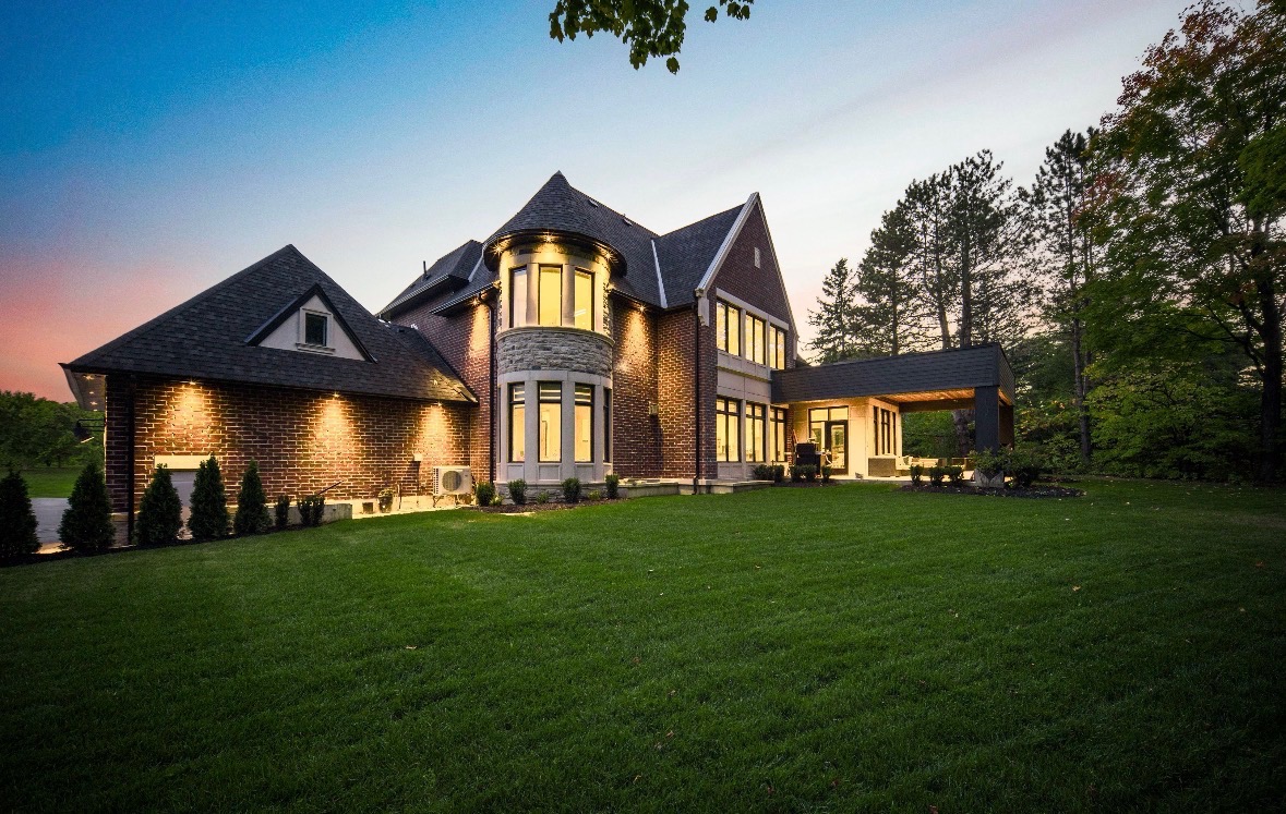 Illustrative landscaped garden with lawn, stone walls and outdoor seating